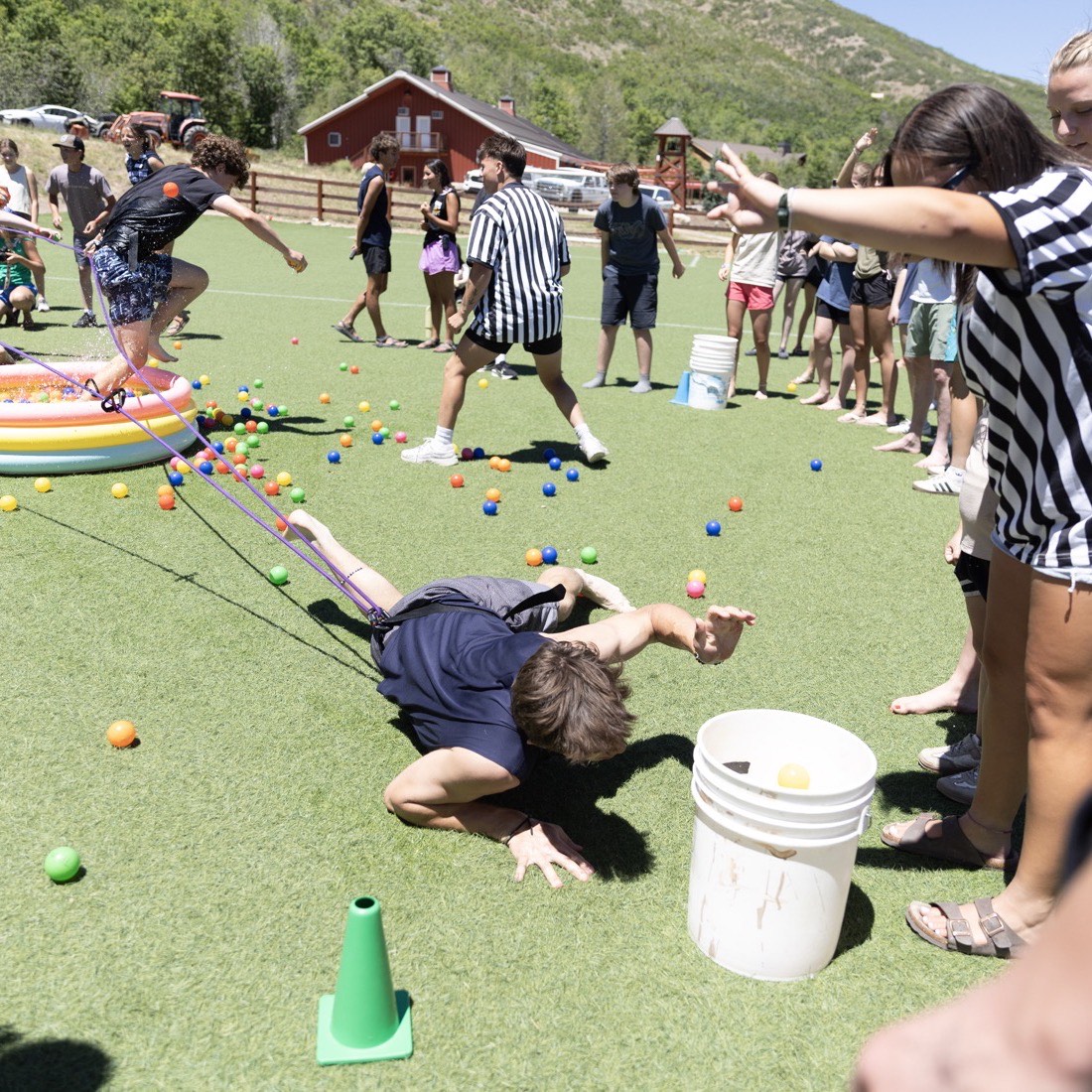 Students playing a big group game on the field at MVF Church in Heber City